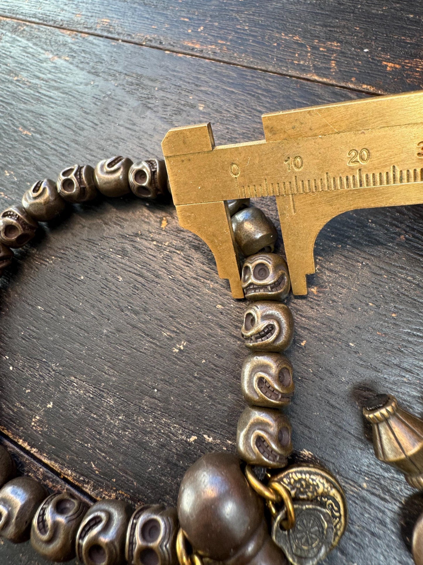 Tibetan Brass Citipati Skull Mala Bracelet | Adjustable 7-8” Wrist Prayer Beads w/ Guru Bead, Lotus Charms, Charnel Ground Amulet
