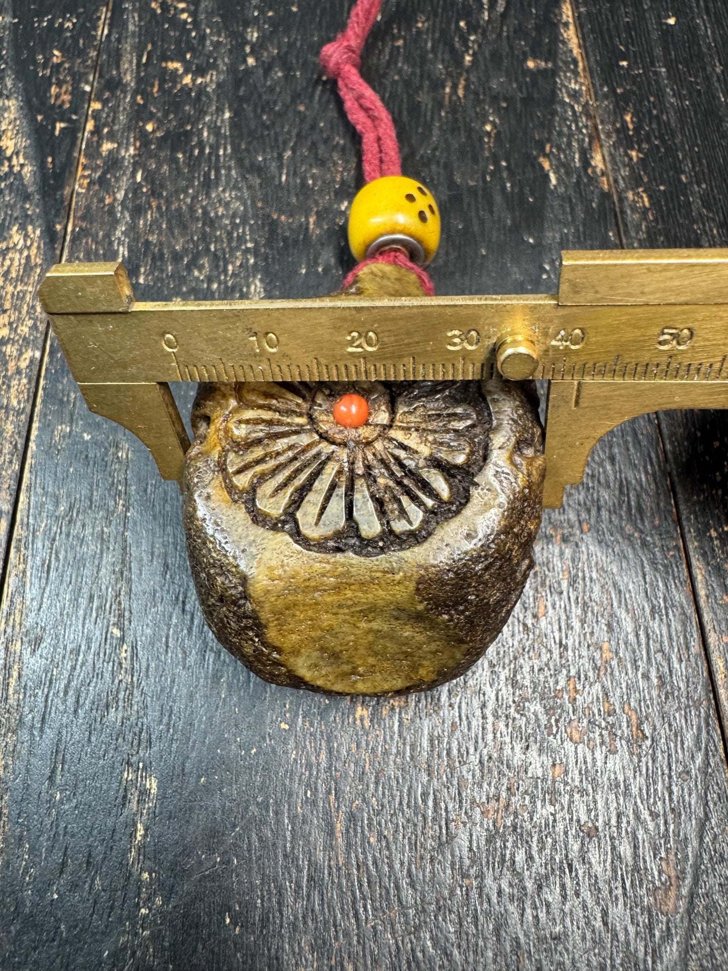 Tibetan Yak Bone Amulet Pendant, Hand Carved Floral Sunburst Design, Tribal Protective Charm, Rustic Spiritual Necklace