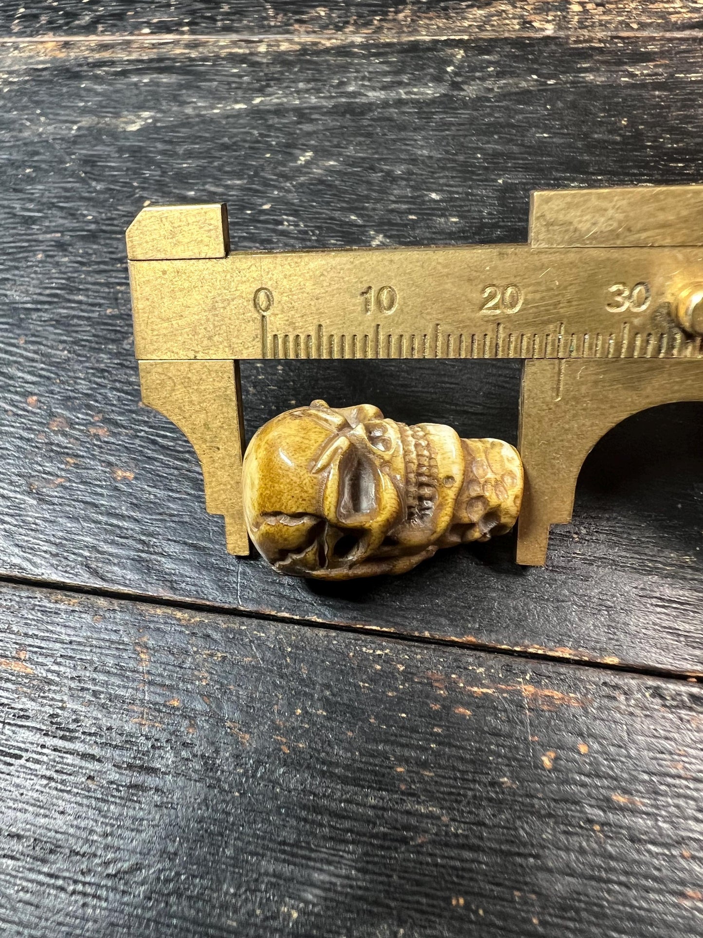 Hand-Carved Deer Antler Citipati Skull Bead with Grasping Bone Hand, Tibetan Charnel Ground Focal Pendant, Vertical Drill