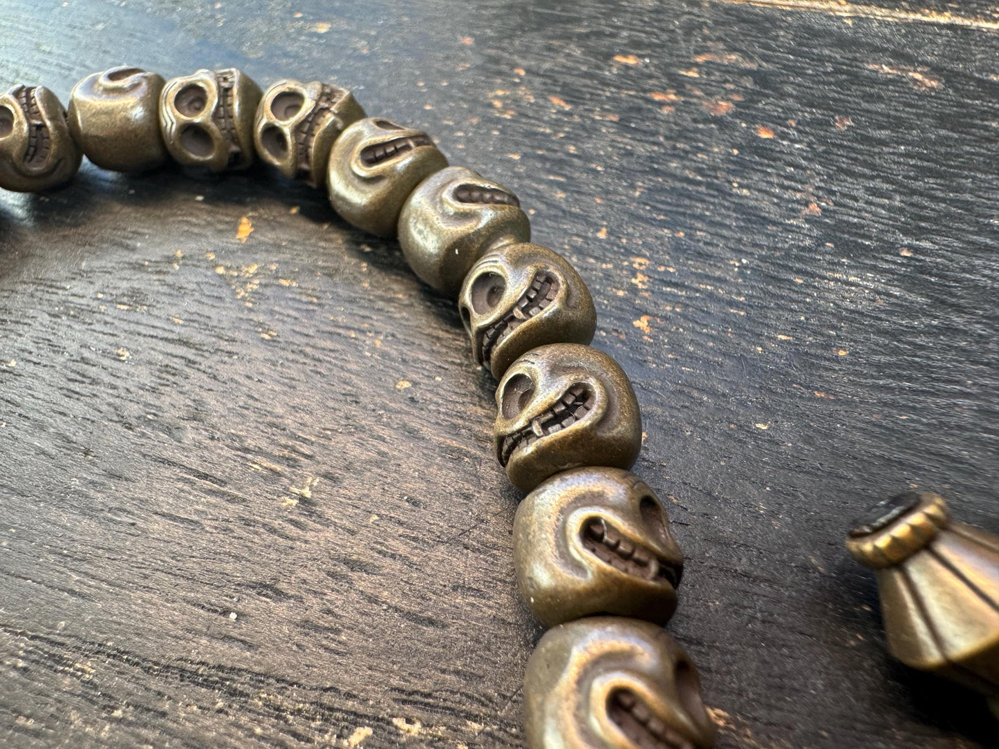 Tibetan Brass Citipati Skull Mala Bracelet | Adjustable 7-8” Wrist Prayer Beads w/ Guru Bead, Lotus Charms, Charnel Ground Amulet