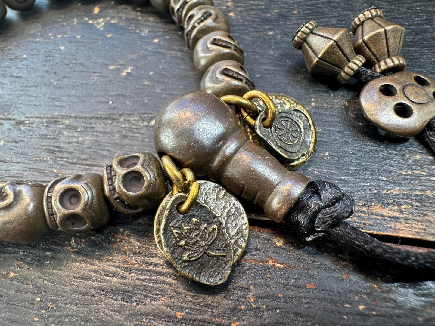 Tibetan Brass Citipati Skull Mala Bracelet | Adjustable 7-8” Wrist Prayer Beads w/ Guru Bead, Lotus Charms, Charnel Ground Amulet